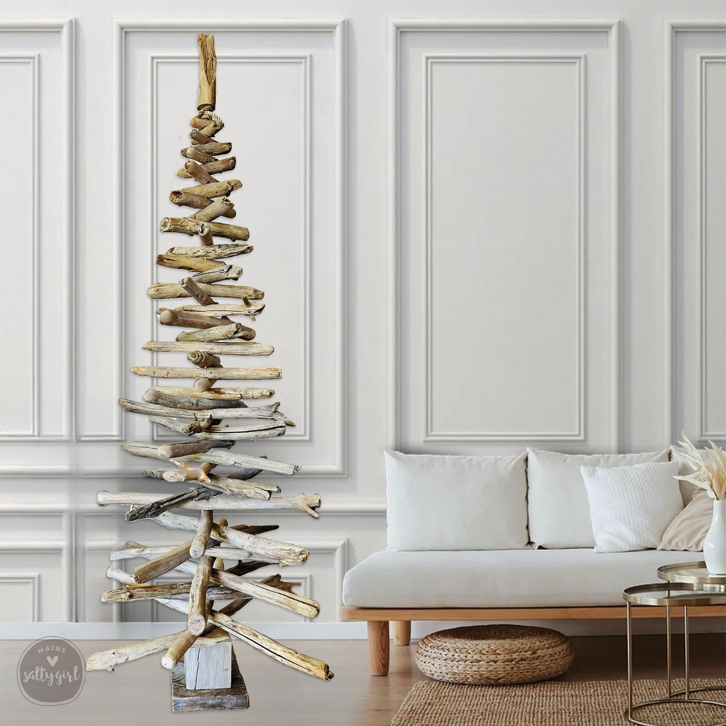 a living room with a white couch and a wooden christmas tree