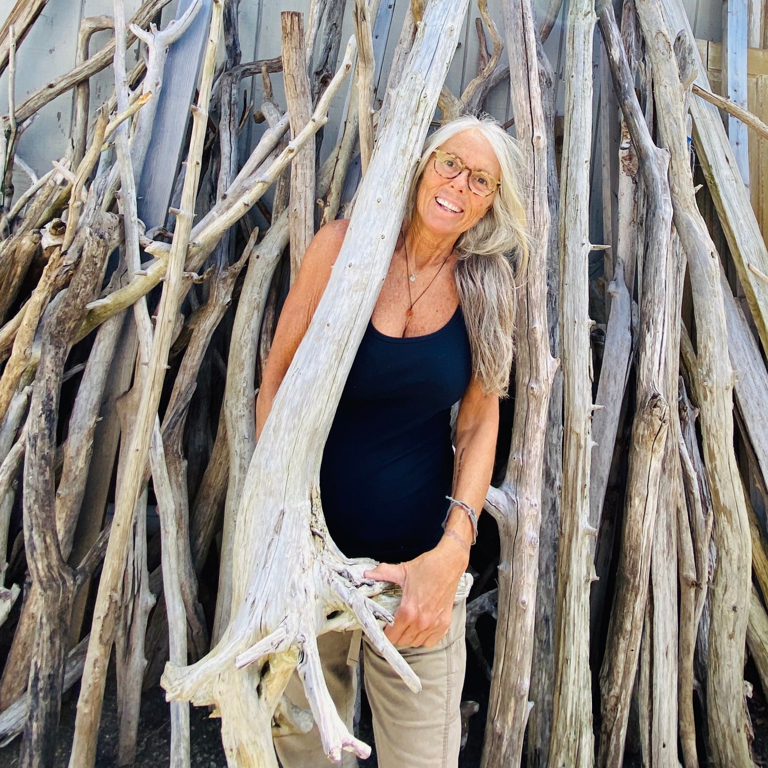 Cherie Herne lifting driftwood tree