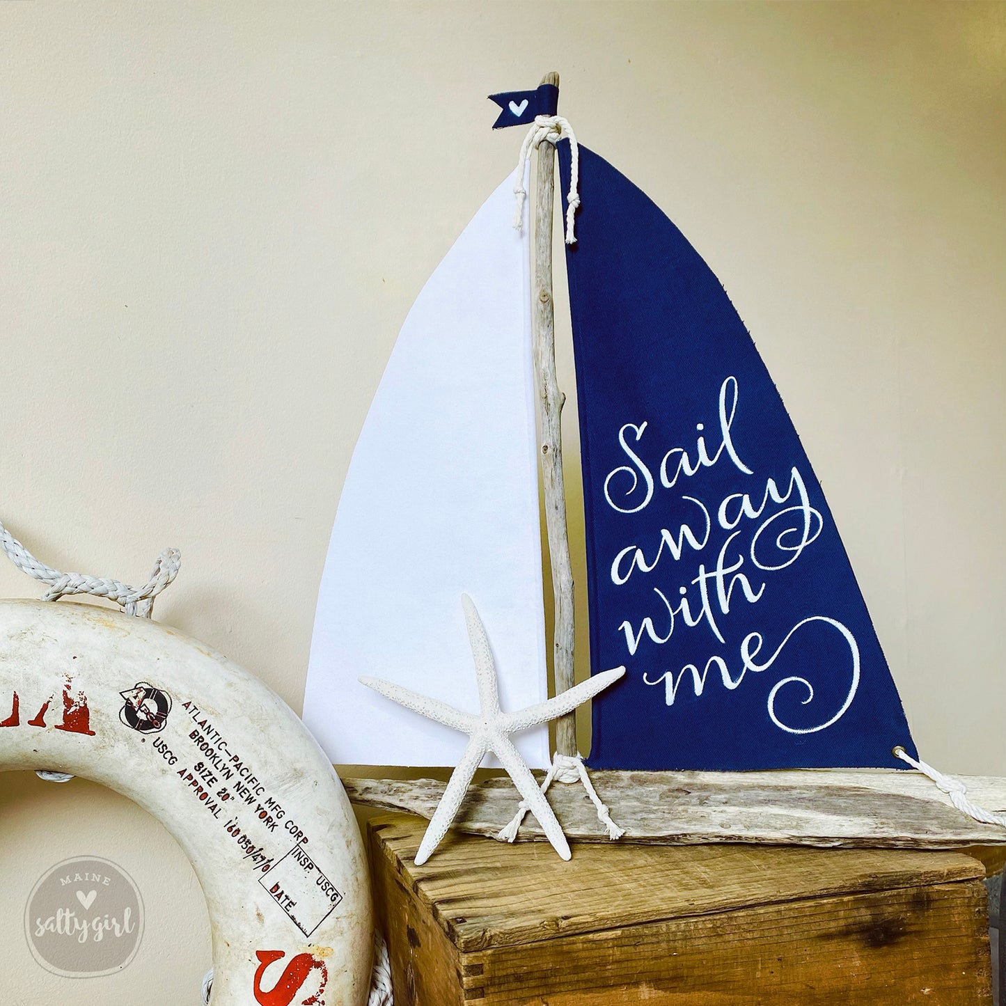a sail boat and life preserver on a table