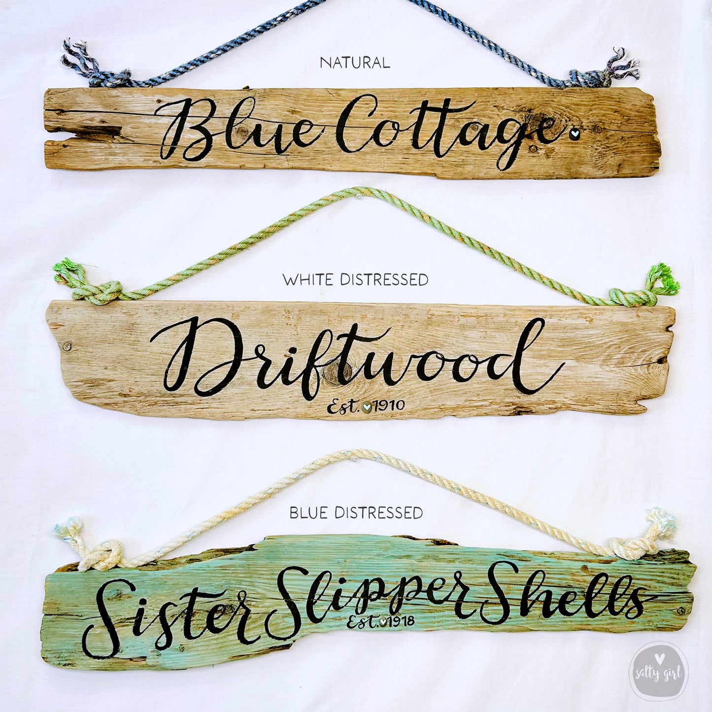 three wooden signs hanging on a wall