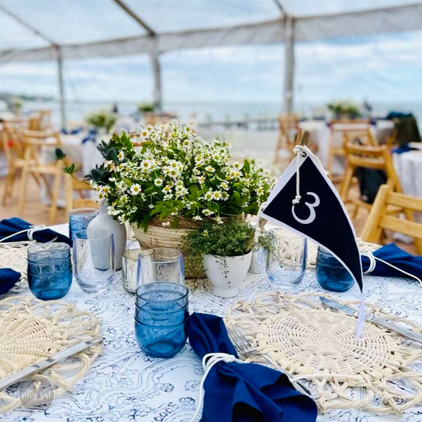blue and white flag table number on a set table with centerpiece