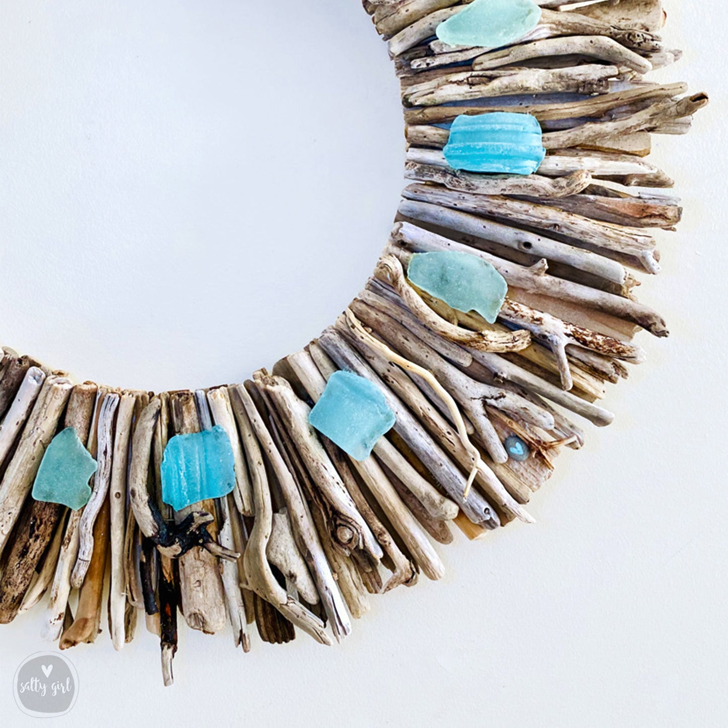 a wreath made out of driftwood and sea glass