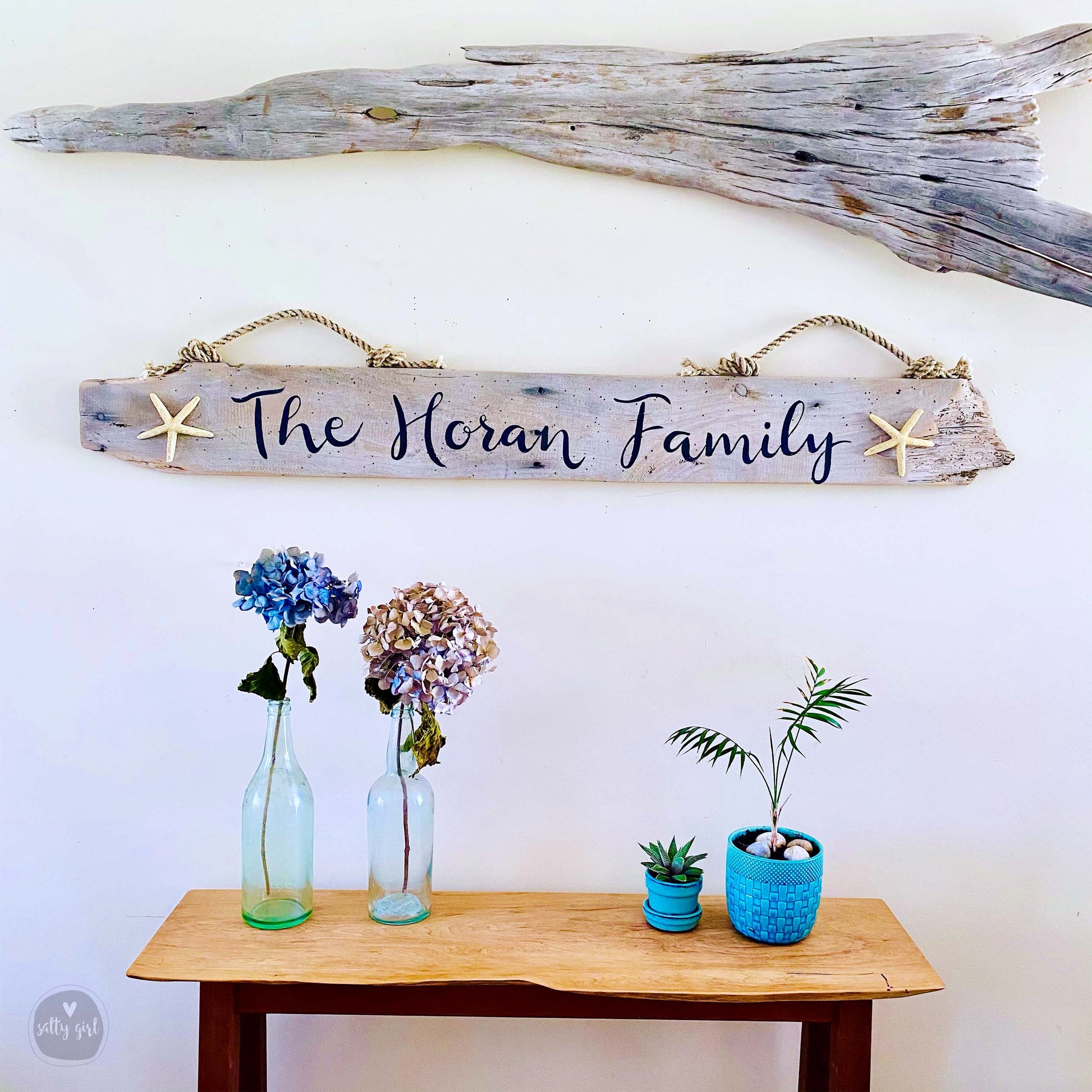 a wooden sign that says the mean family hanging on a wall