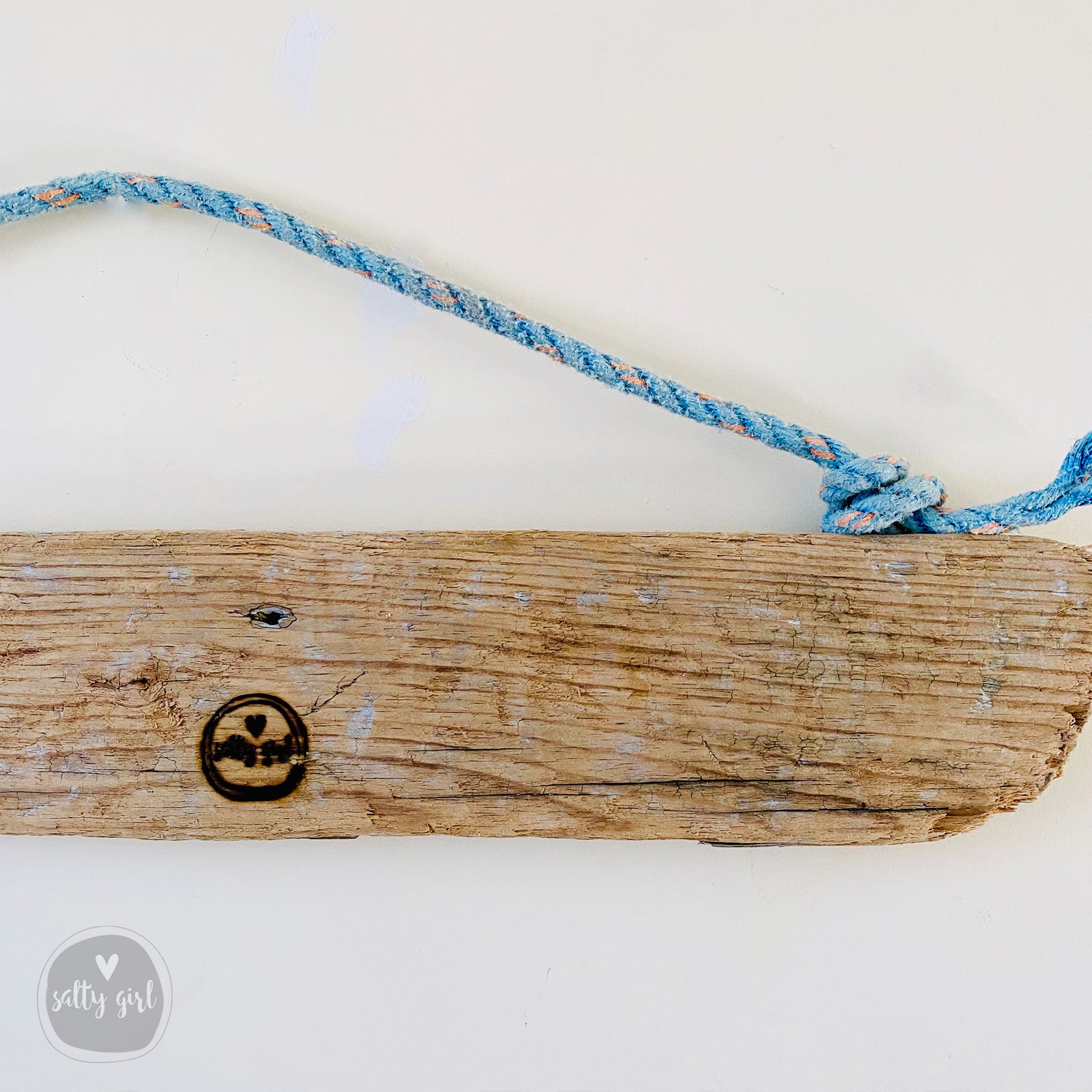 a wooden sign with a smiley face on it