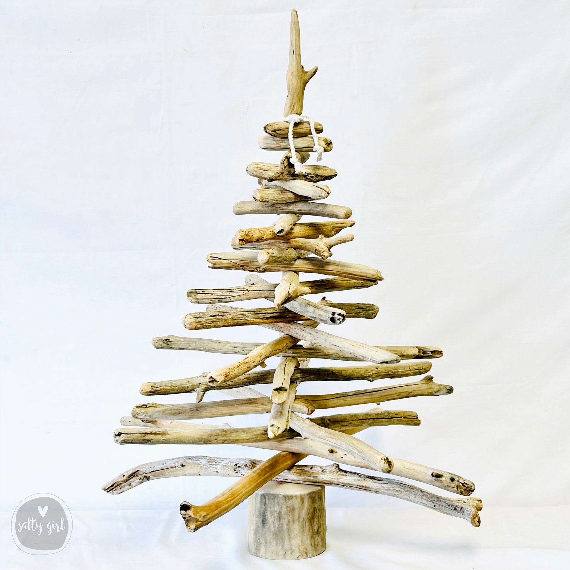a wooden christmas tree made out of driftwood