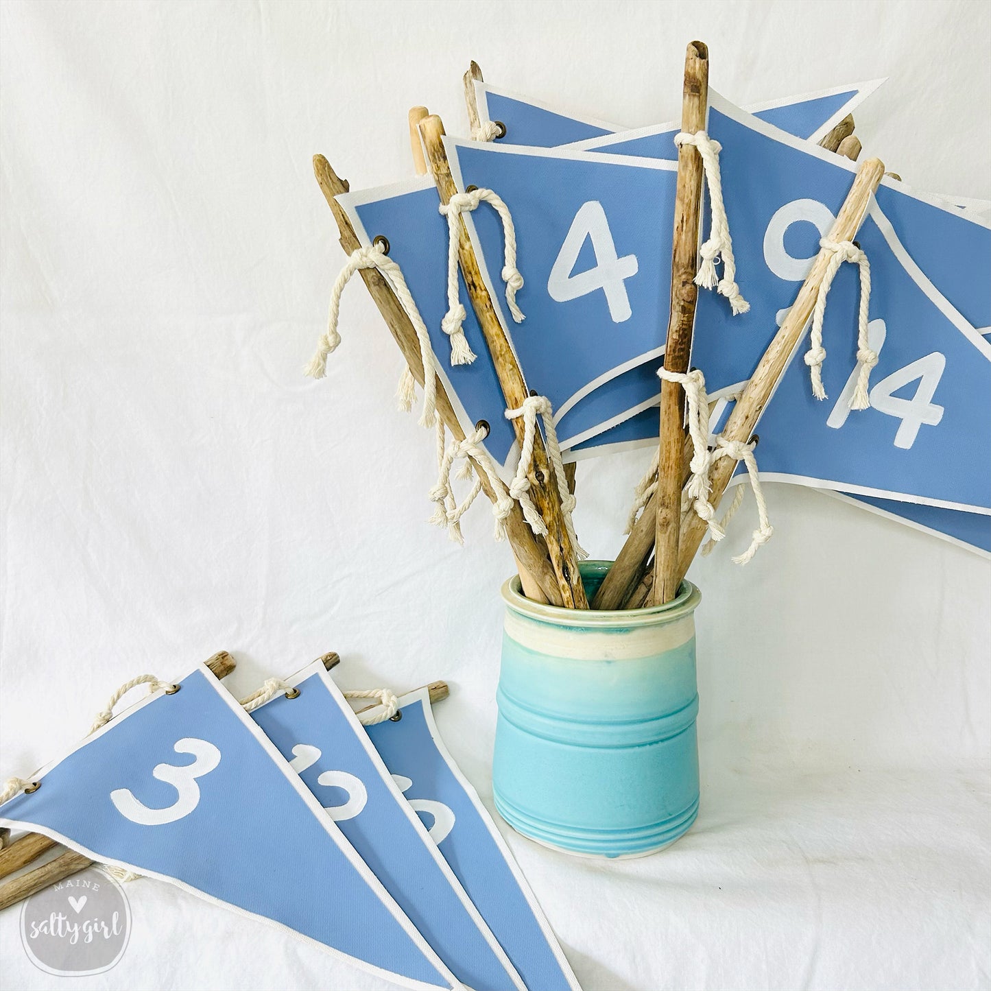 a vase filled with sticks and a number sign