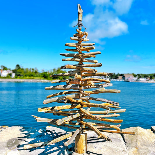 driftwood Christmas tree next to water