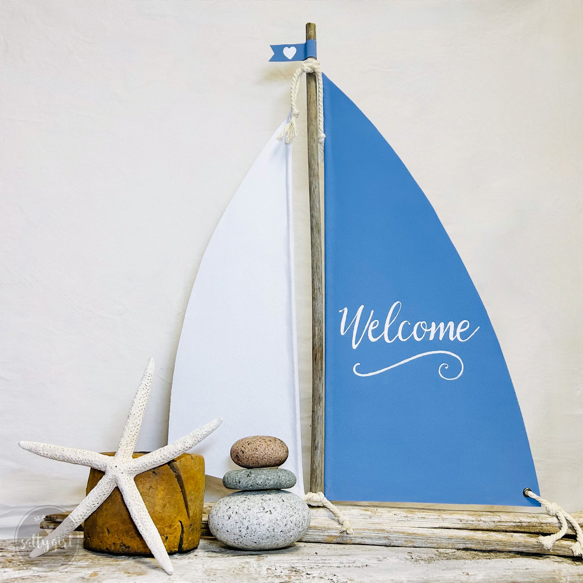 a blue sailboat sitting next to a starfish