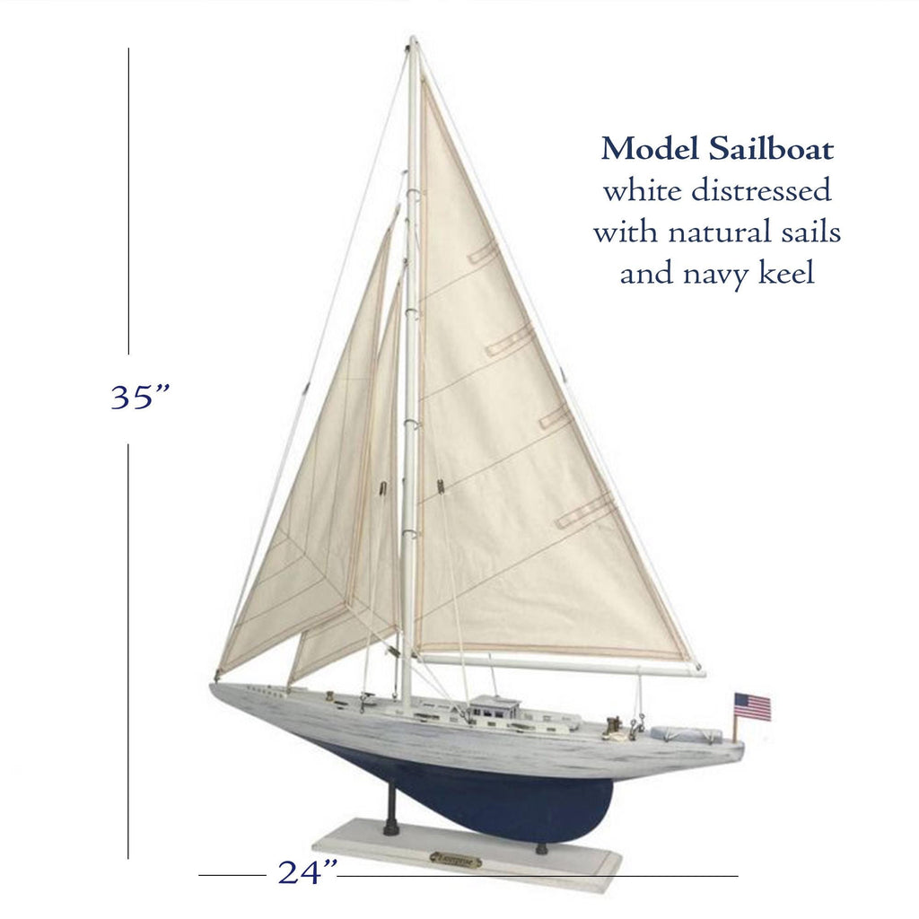 a model sailboat with a white hull and sails, and it is described as a 35-inch sailboat with natural sails and navy keel.