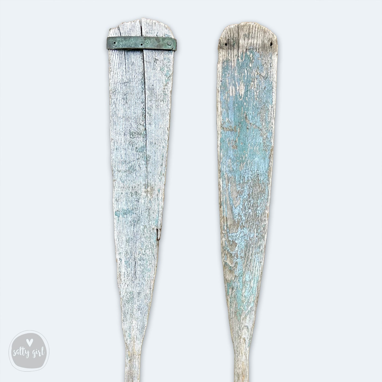 a pair of wooden paddles sitting next to each other