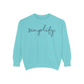 A turquoise-colored Maine Salty Girl sweatshirt with the word "simplify" printed on it in a cursive font.