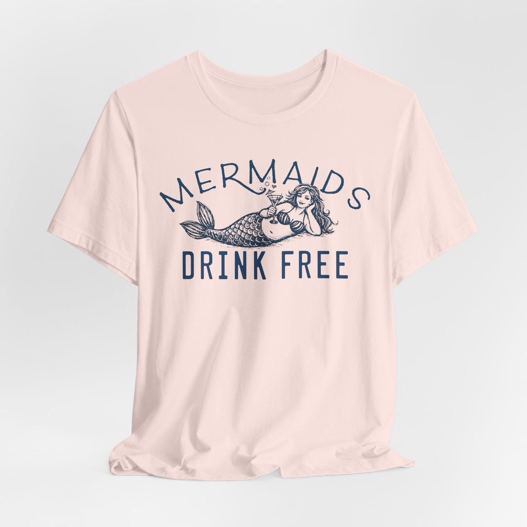 A pink Maine Salty Girl T-shirt with a graphic design featuring a mermaid and the text "Mermaids DRINK FREE".