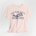 A pink Maine Salty Girl T-shirt with a graphic design featuring a mermaid and the text "Mermaids DRINK FREE".