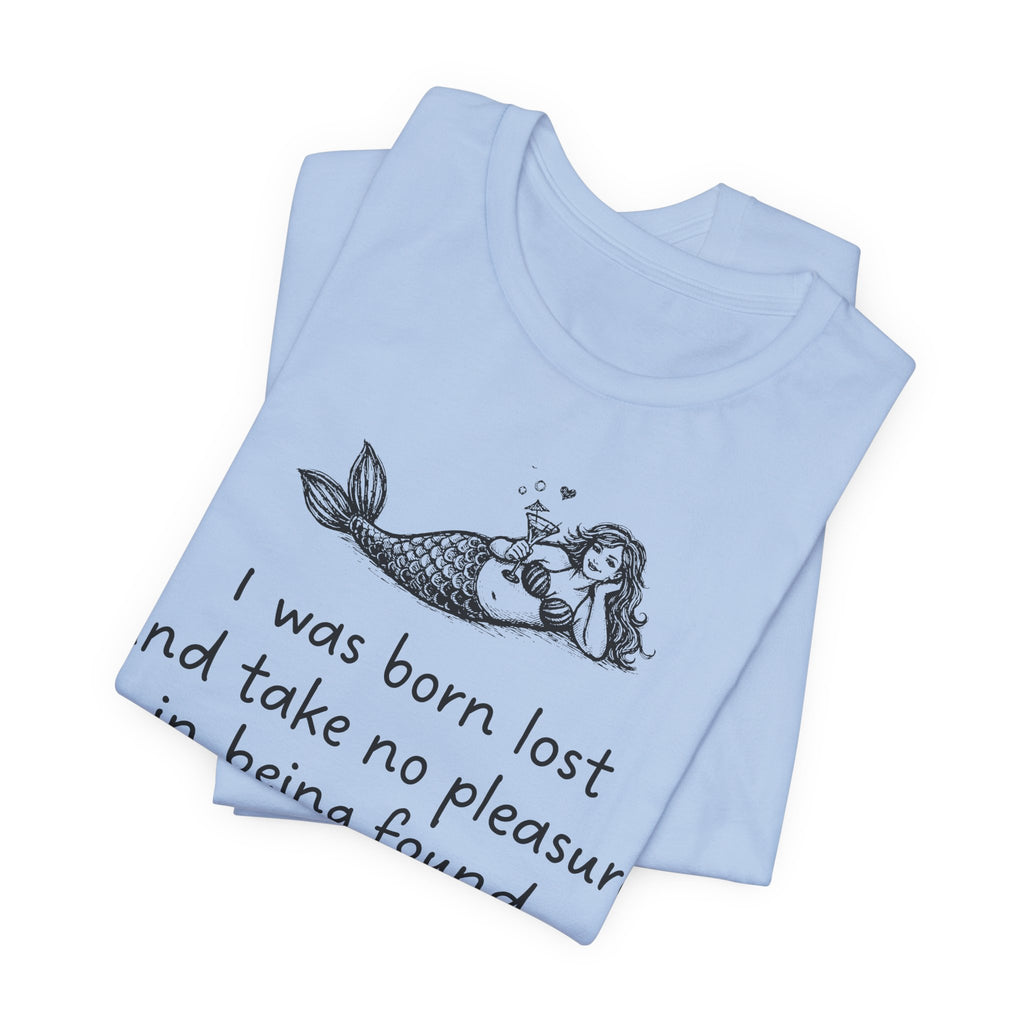 A light blue Maine Salty Girl t-shirt with a graphic of a mermaid and a quote "I was born lost and take no pleasure in being found"