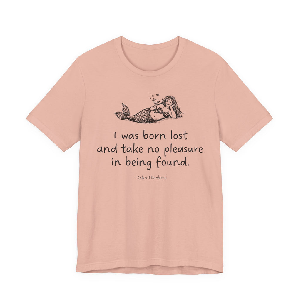 The image is a pink Maine Salty Girl t-shirt with a graphic of a mermaid and a quote "I was born lost and take no pleasure in being found"