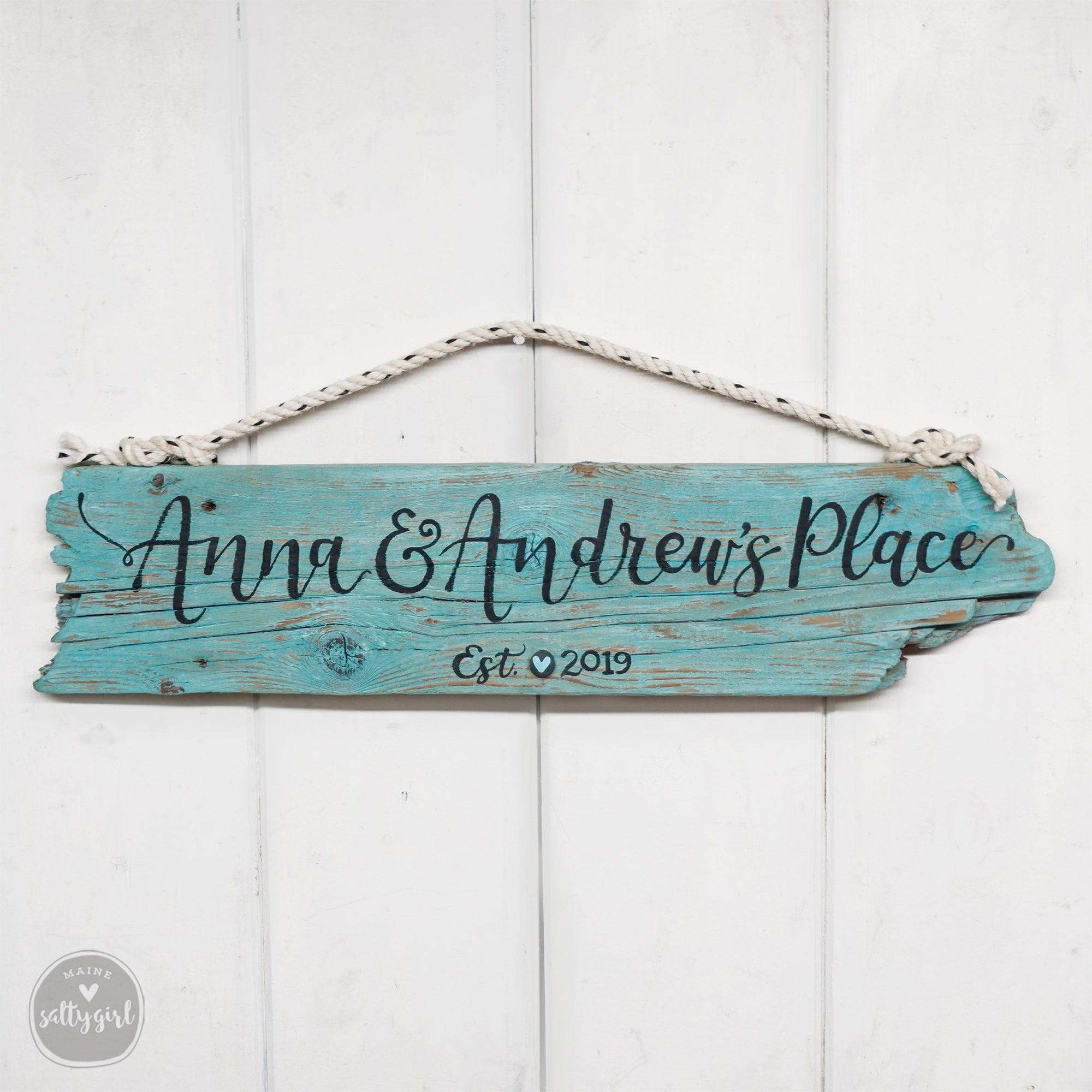 a wooden sign hanging on a white wall