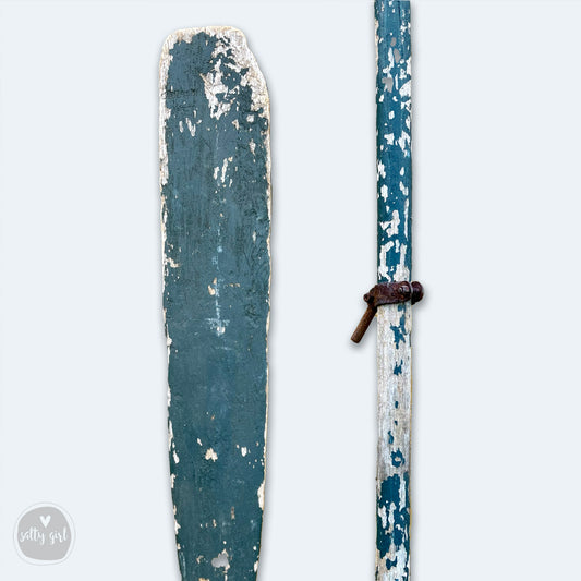 an old pair of skis with a rusted handle