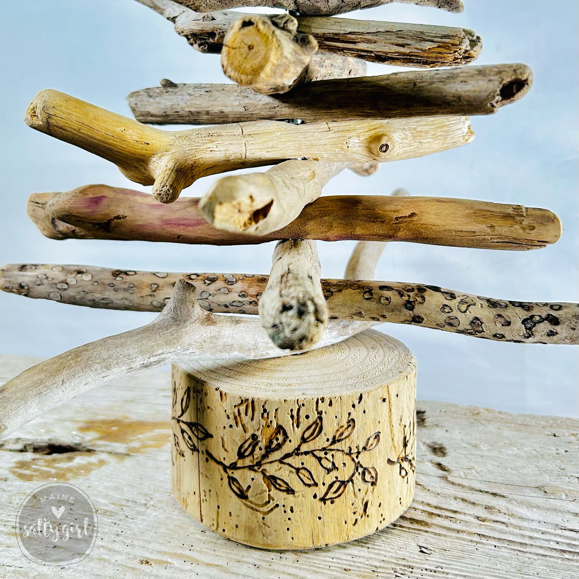 a collection of various natural branches and sticks arranged in a creative manner, resembling a tree or a decorative piece.