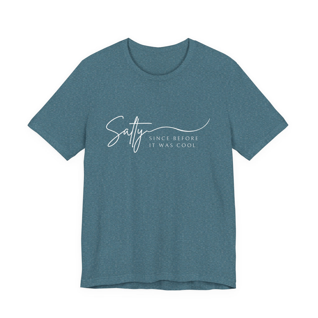 A teal-colored t-shirt with the text "Salty Since before it was cool" printed on it.