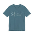 A teal-colored t-shirt with the text "Salty Since before it was cool" printed on it.