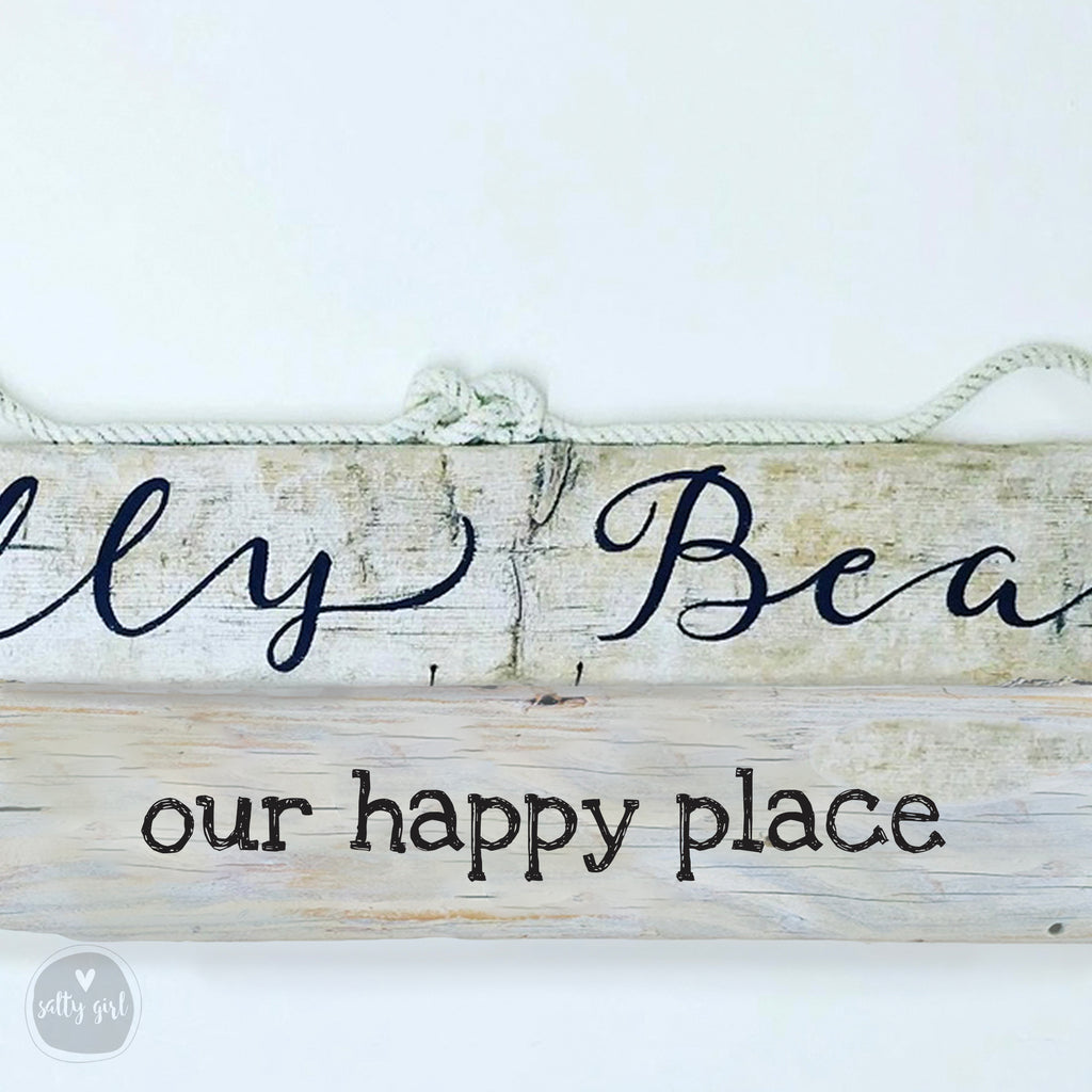 A wooden sign with the text "Our happy place" written on it, along with a rope tied around it.