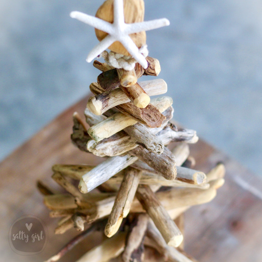 A close-up image of a creative arrangement of driftwood and a starfish, showcasing the natural beauty of the materials.