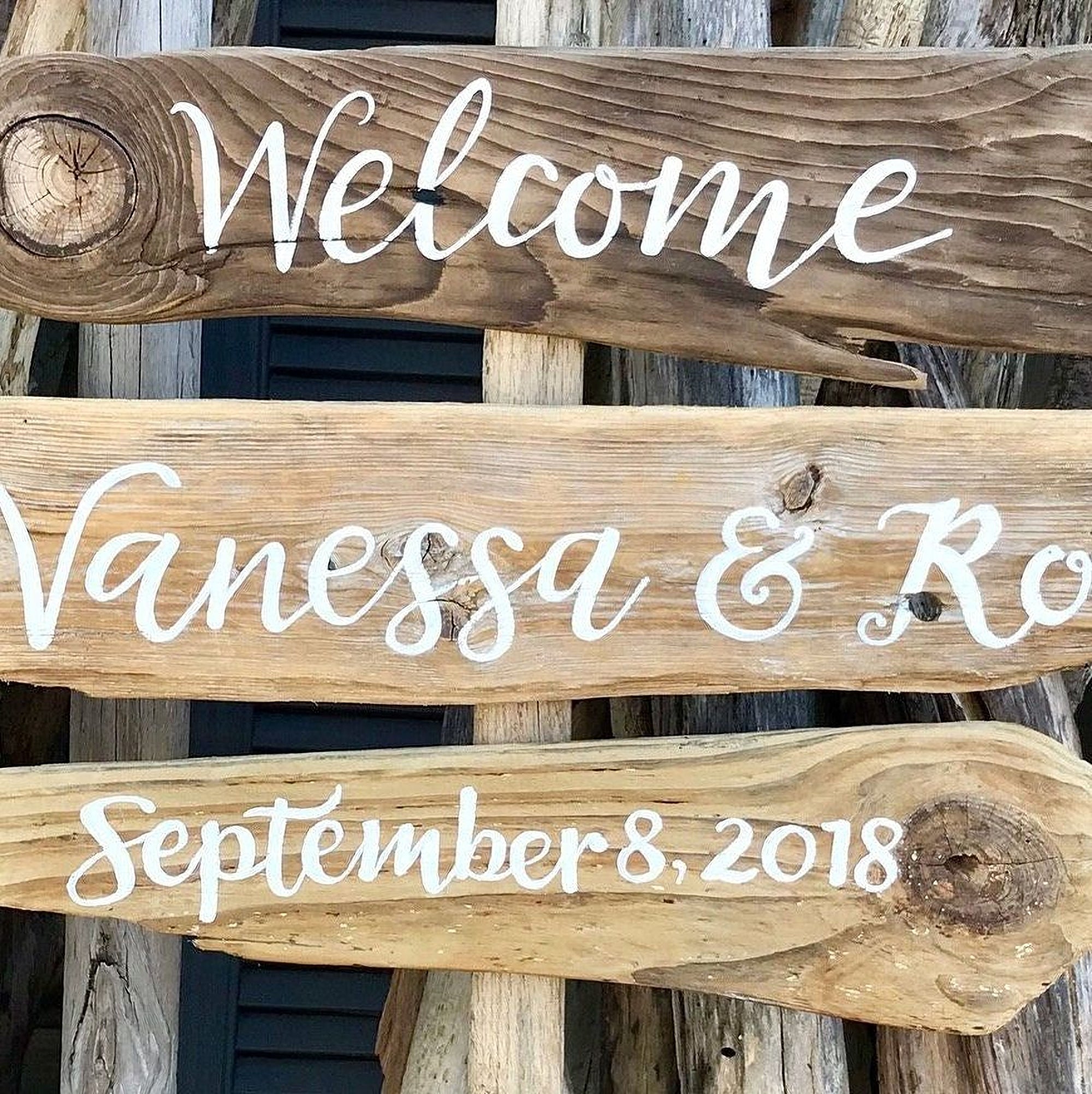 a wooden sign with the names 'Venessa & Ro' written on it, along with the date 'September 8, 2018'.