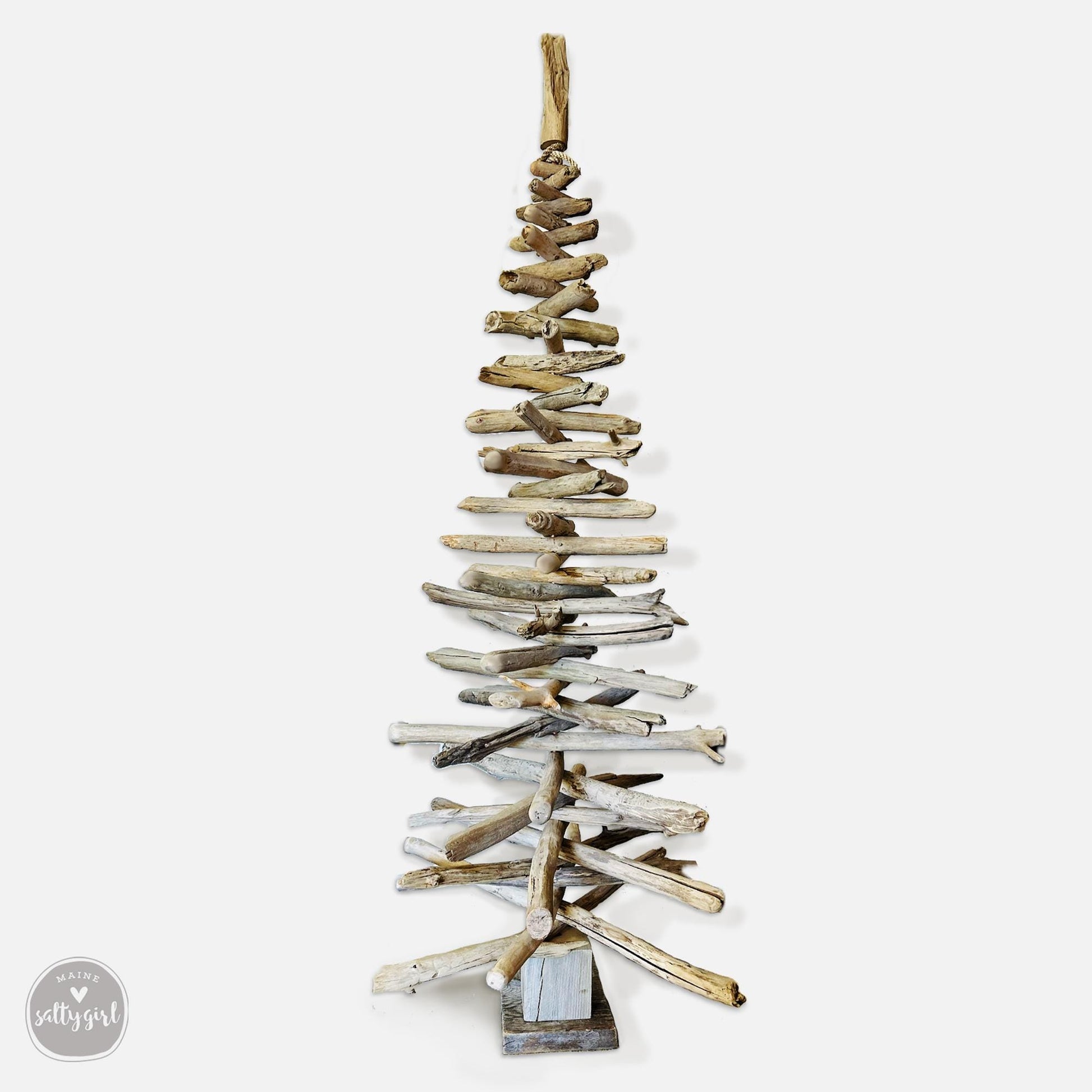 a wooden christmas tree made out of driftwood