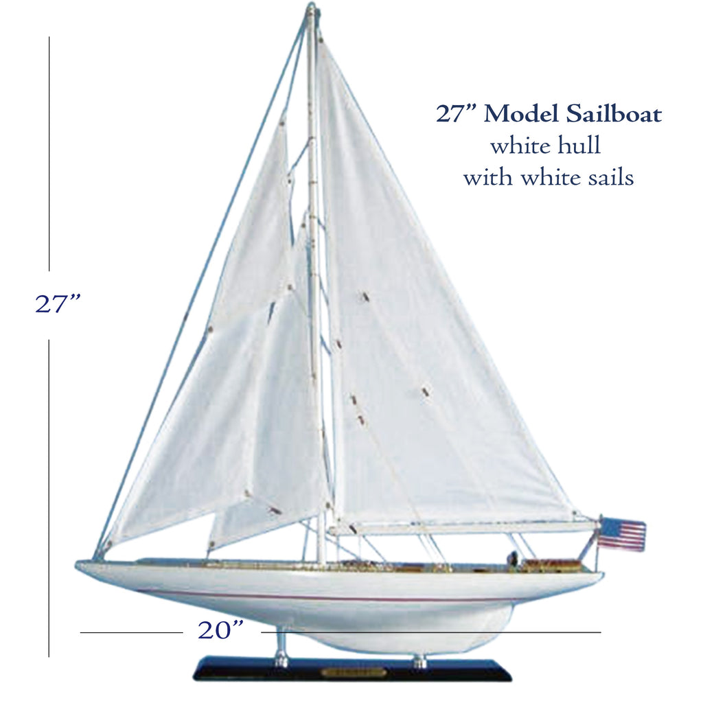 A model sailboat with white hull and white sails, measuring 27 inches in length and 20 inches in width.