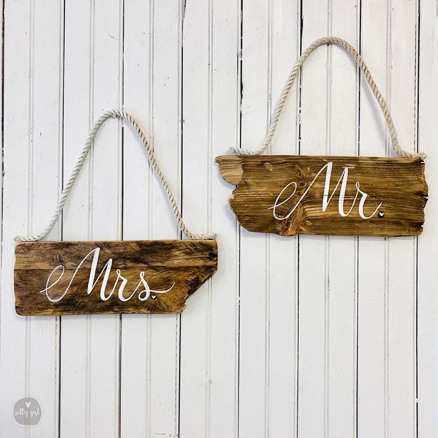 a couple of wooden signs hanging on a wall