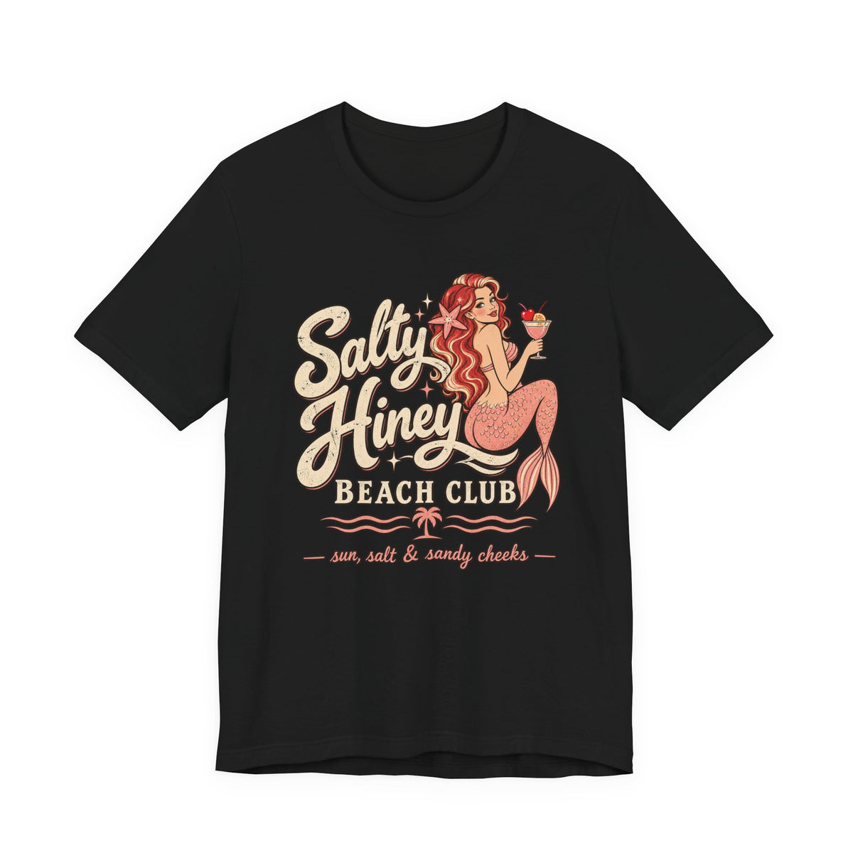 A black t-shirt with a graphic design featuring a mermaid holding a drink and the text "Salt Honey Beach Club sun, salt & sandy cheeks" printed on it.