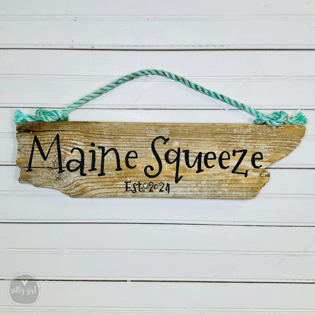 a wooden sign hanging on the side of a building