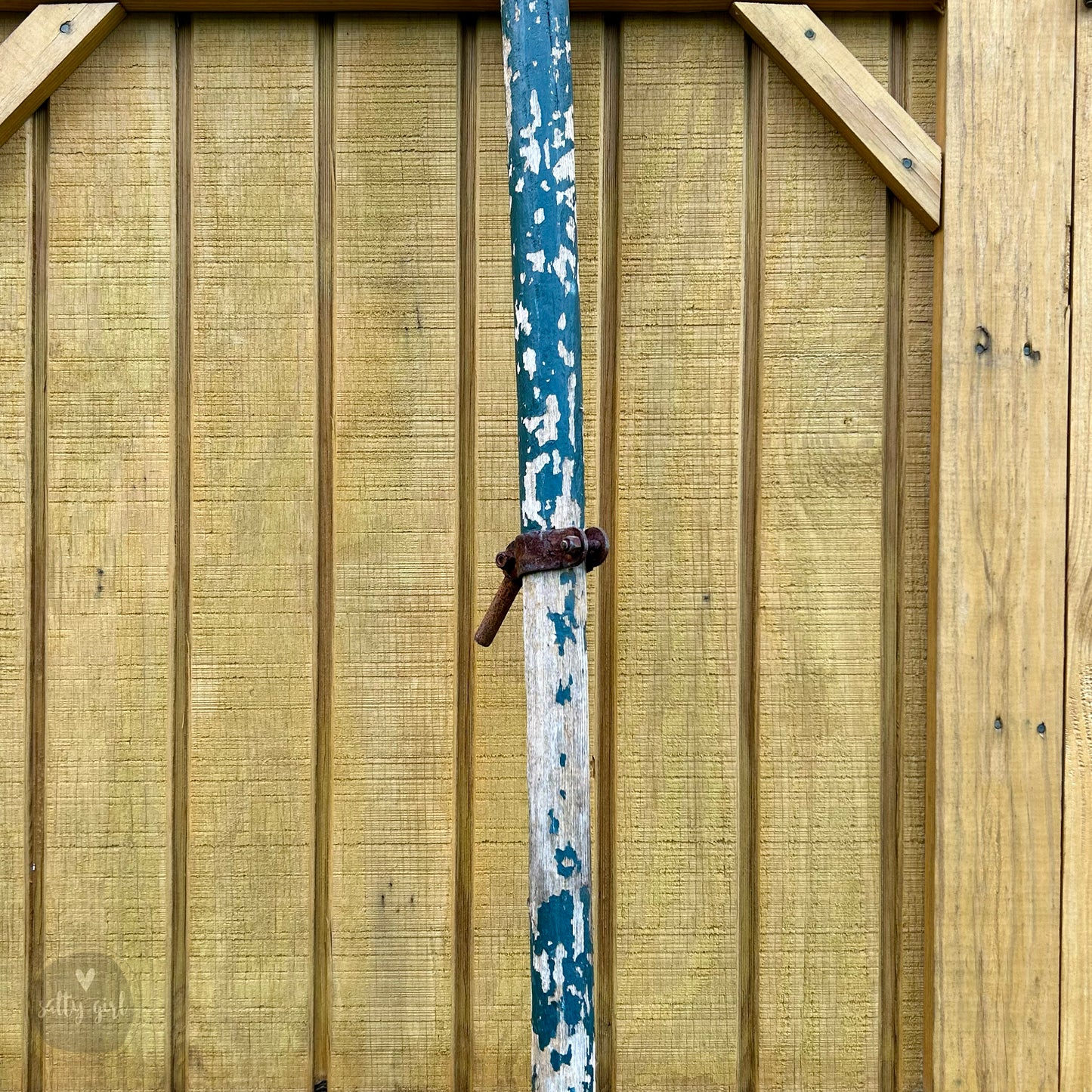 a wooden fence with a blue and white pole