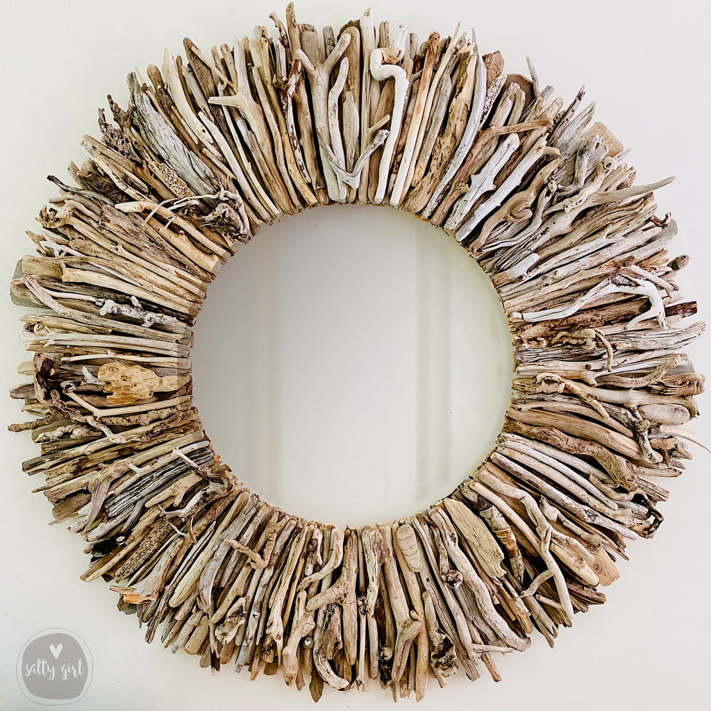 A circular wreath made of various branches and twigs, creating a rustic and natural appearance.