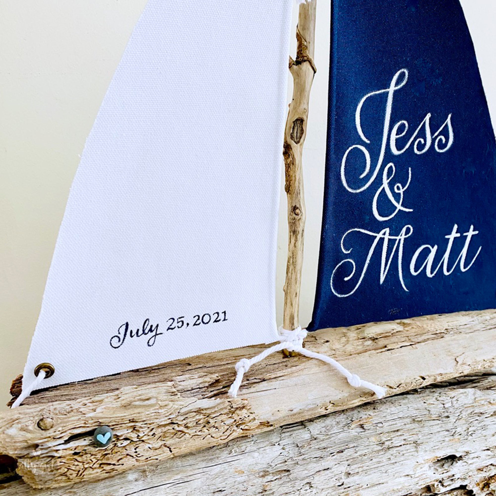 a wooden sailboat with a blue sail on top of it