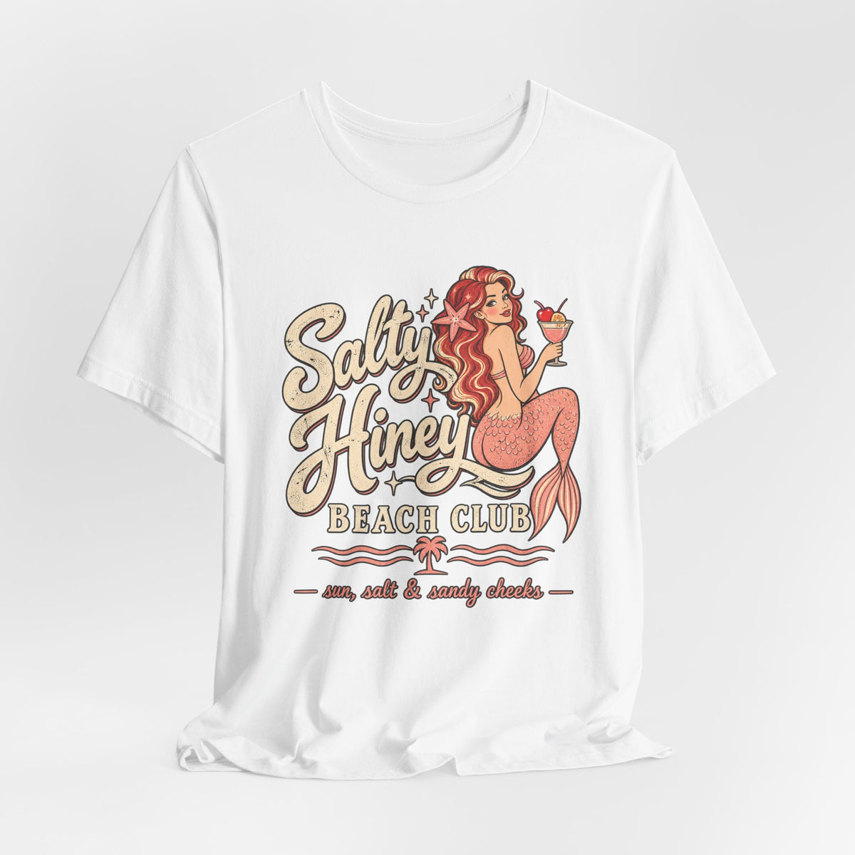 A white t-shirt with a graphic design featuring a mermaid and the text "Salt & Honey Beach Club" printed on it.