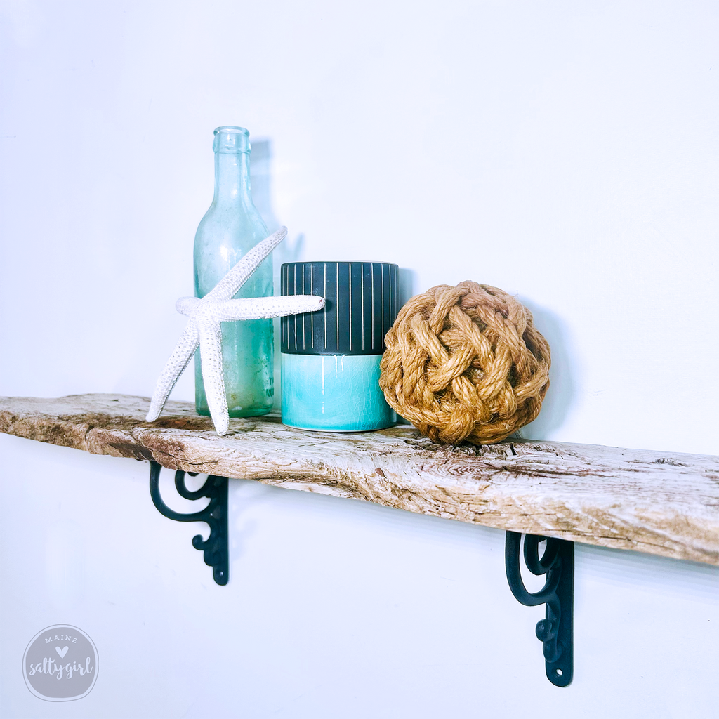 a wooden shelf with a rope ball and a bottle on it