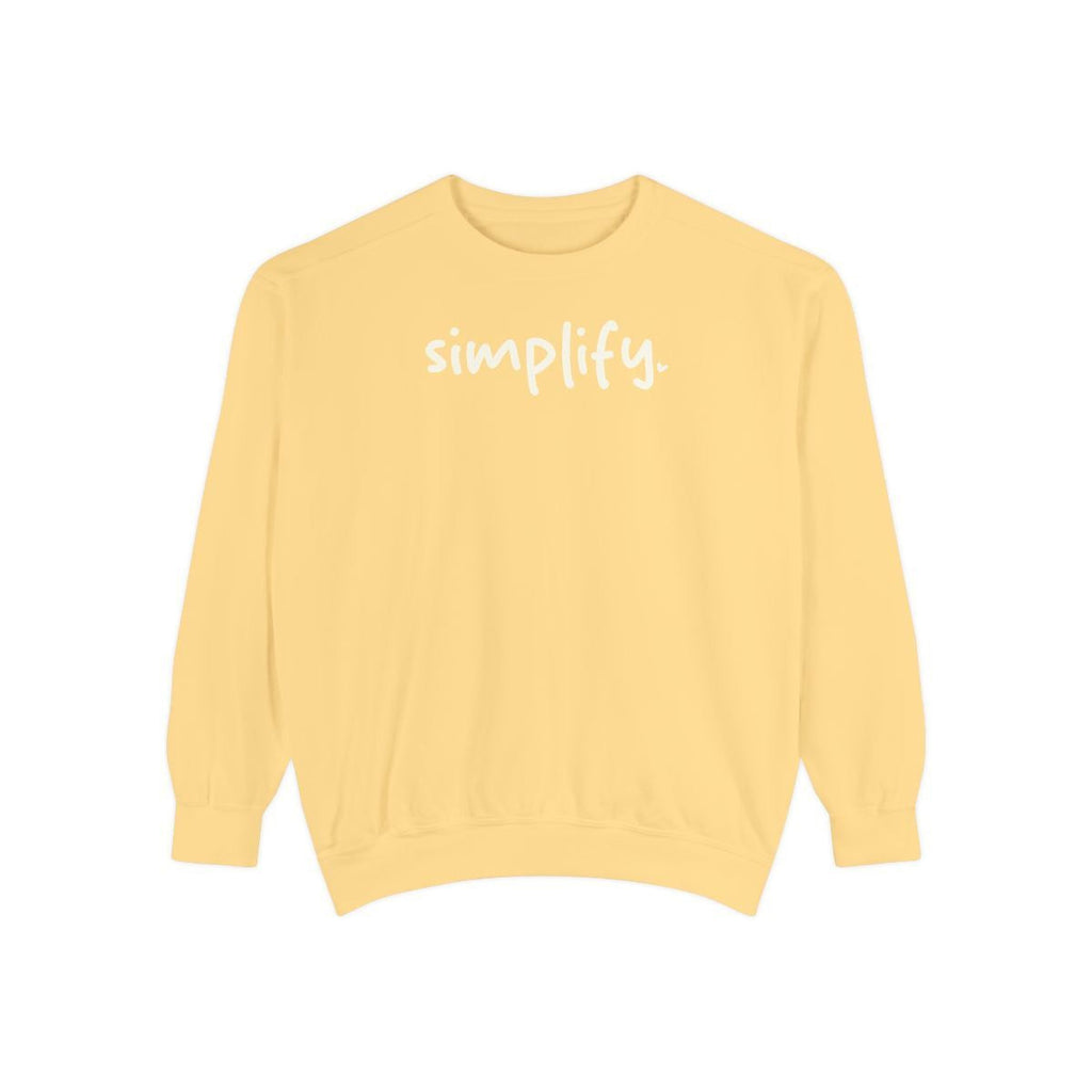 A yellow Maine Salty Girl sweatshirt with the word "simplify" printed on it in white text.