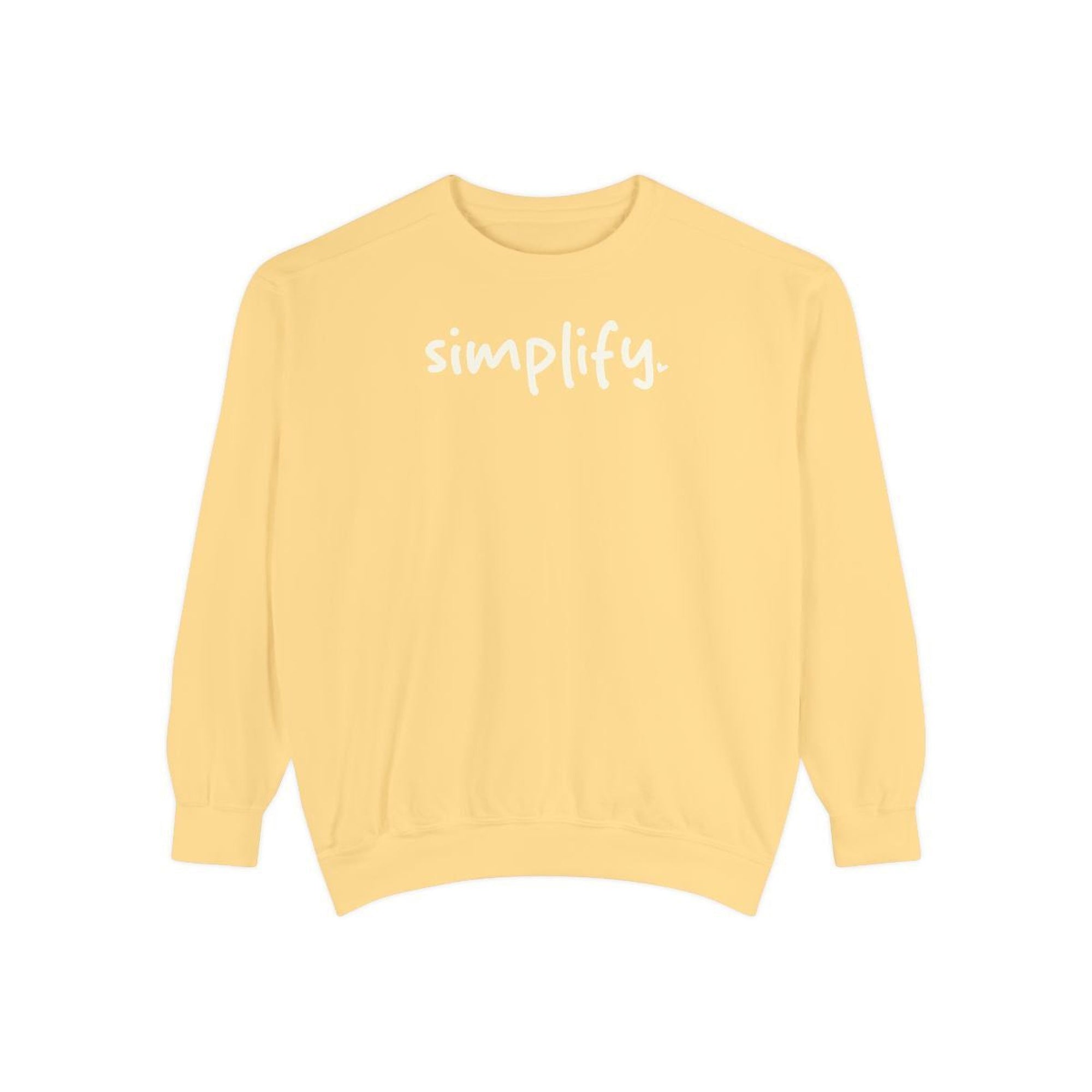 A yellow Maine Salty Girl sweatshirt with the word "simplify" printed on it in white text.