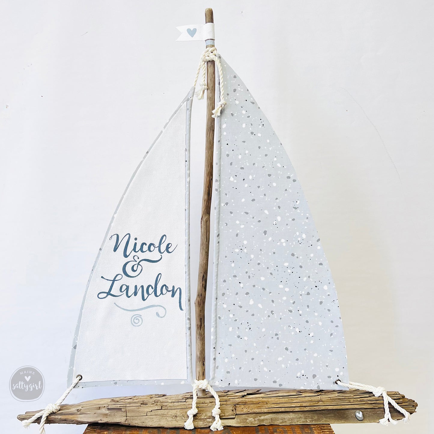 a small sail boat on a wooden stand