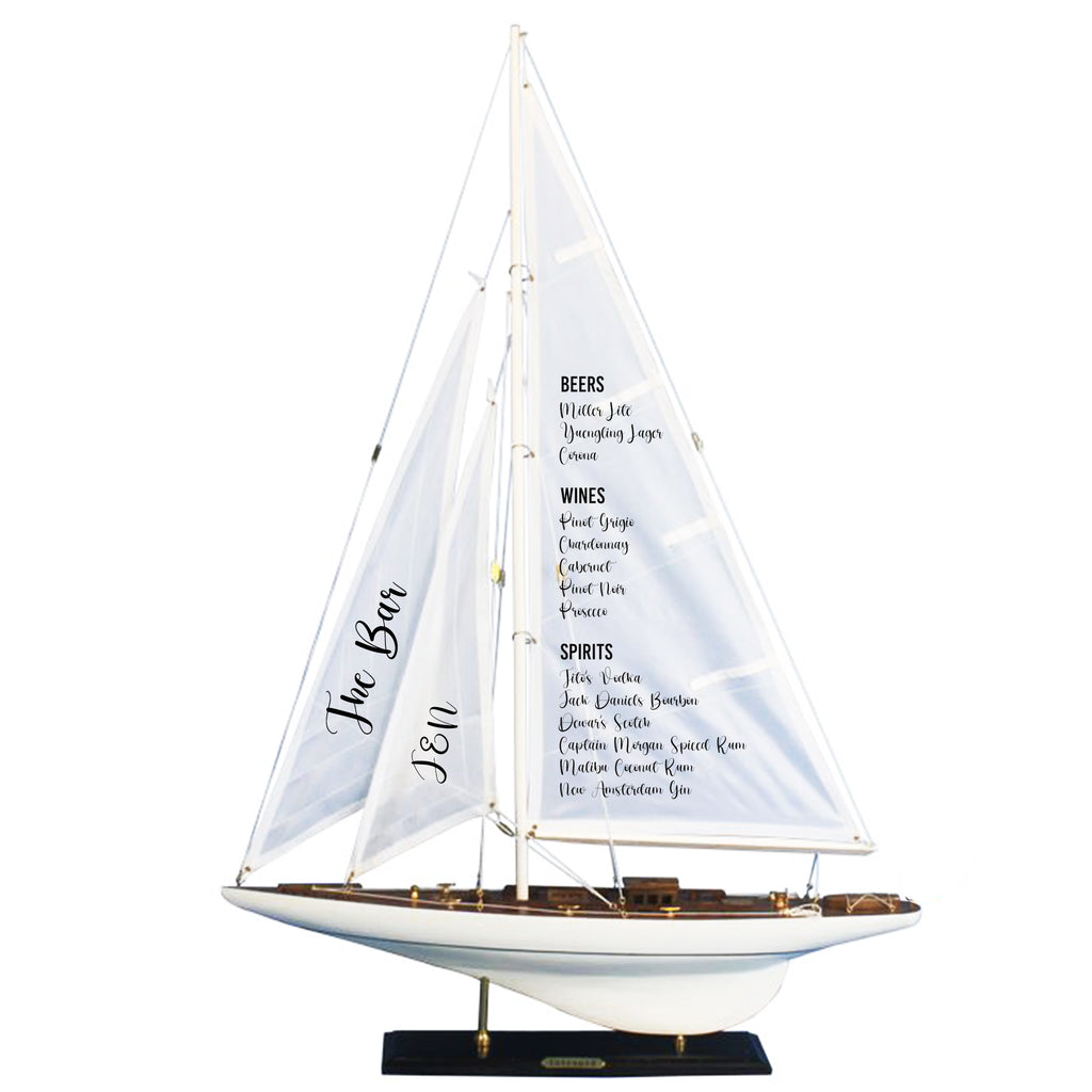 A model of a sailboat with a menu displayed on its sails.