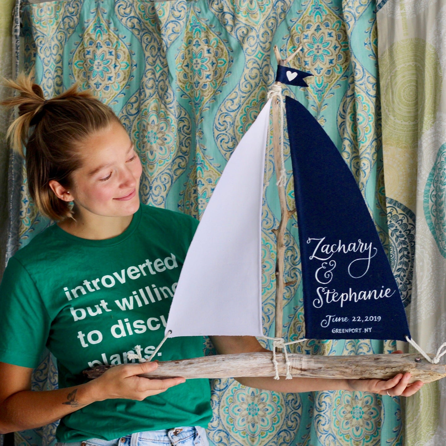 Girl holding 24" driftwood sailboat