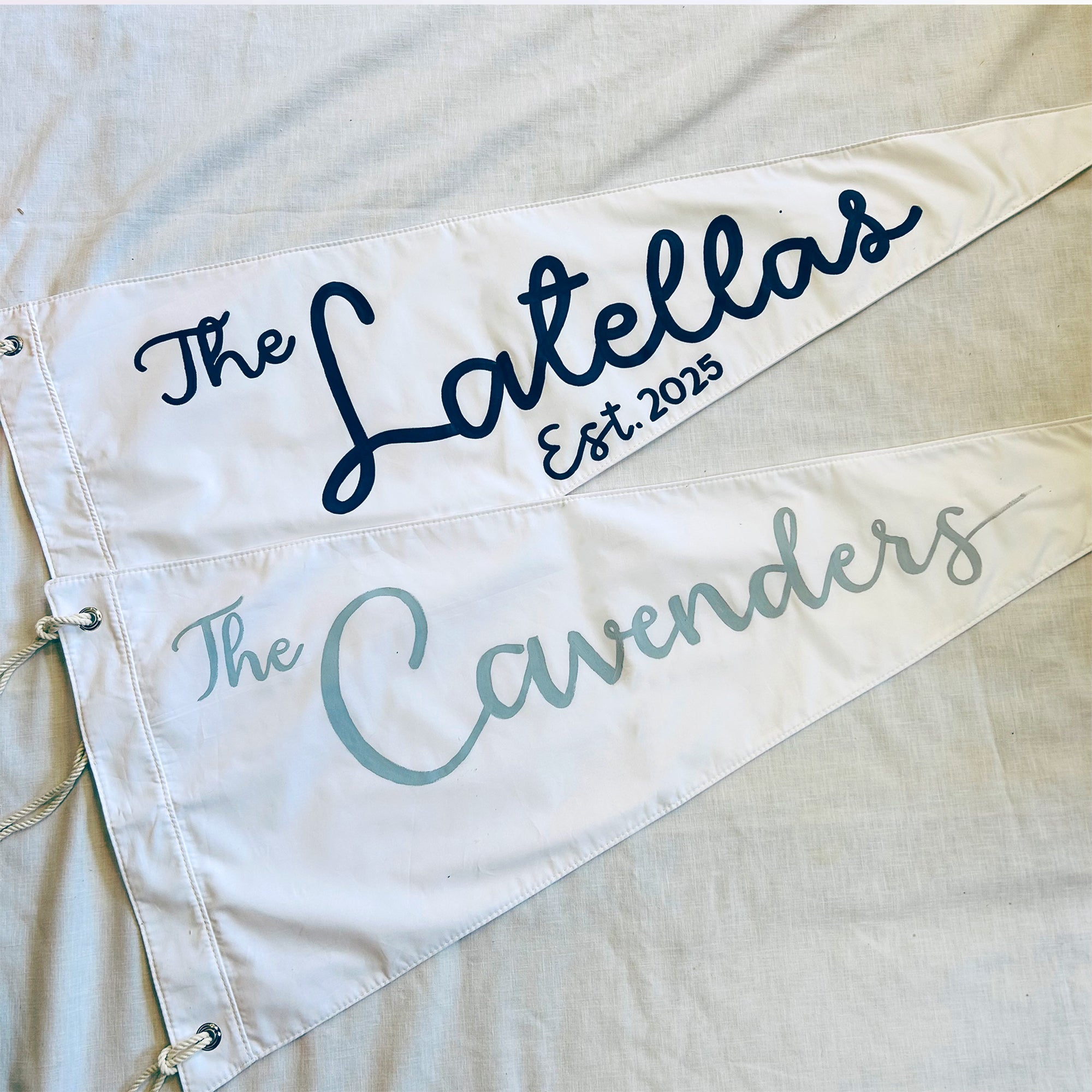 Personalized pennant with 'The Latellas' and 'The Cavenders' text on a light background