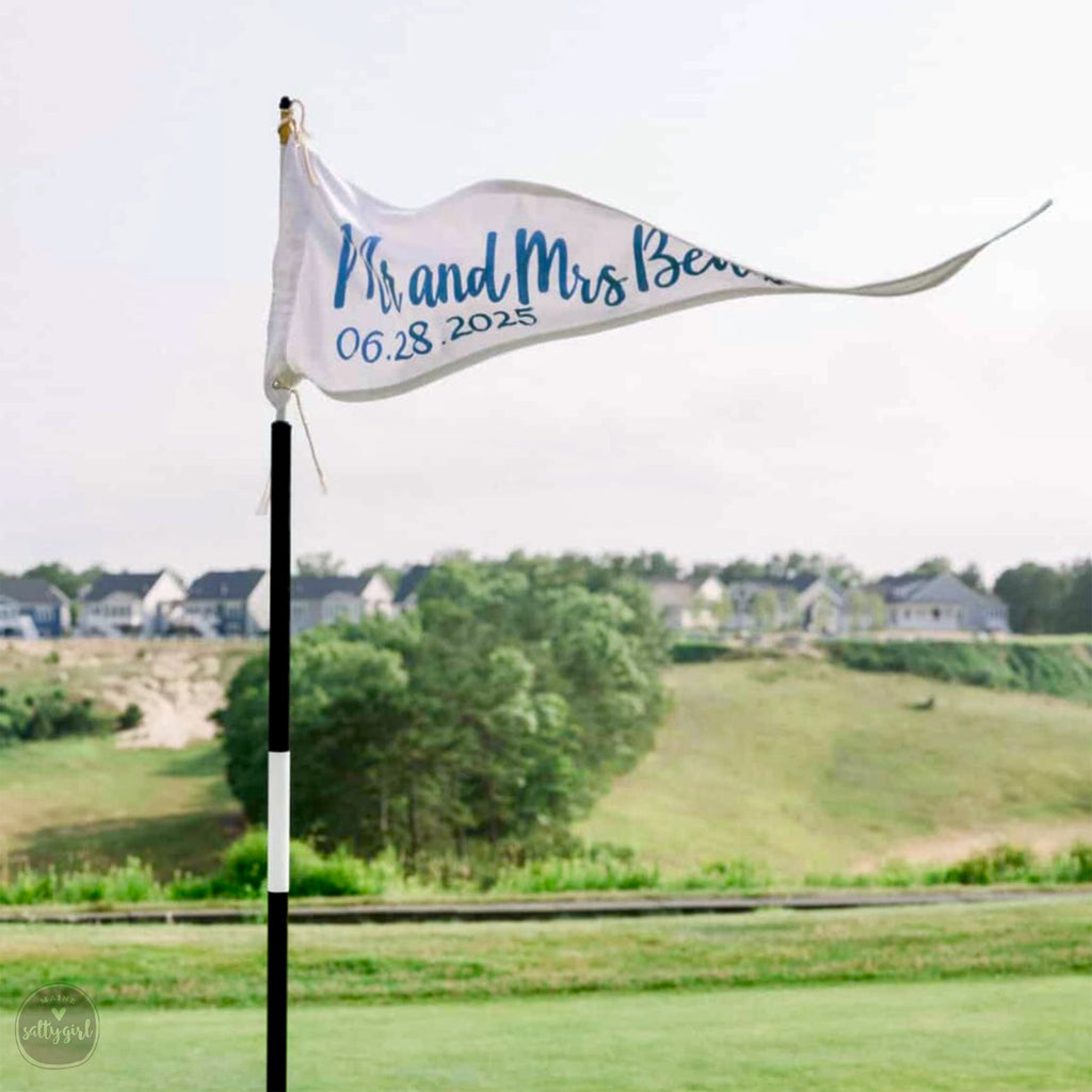 Golf flag with text on a golf course with houses and trees in the background