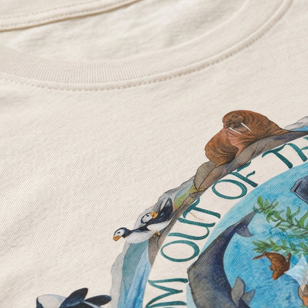Close-up of a white shirt with an ocean-themed design featuring animals and text.
