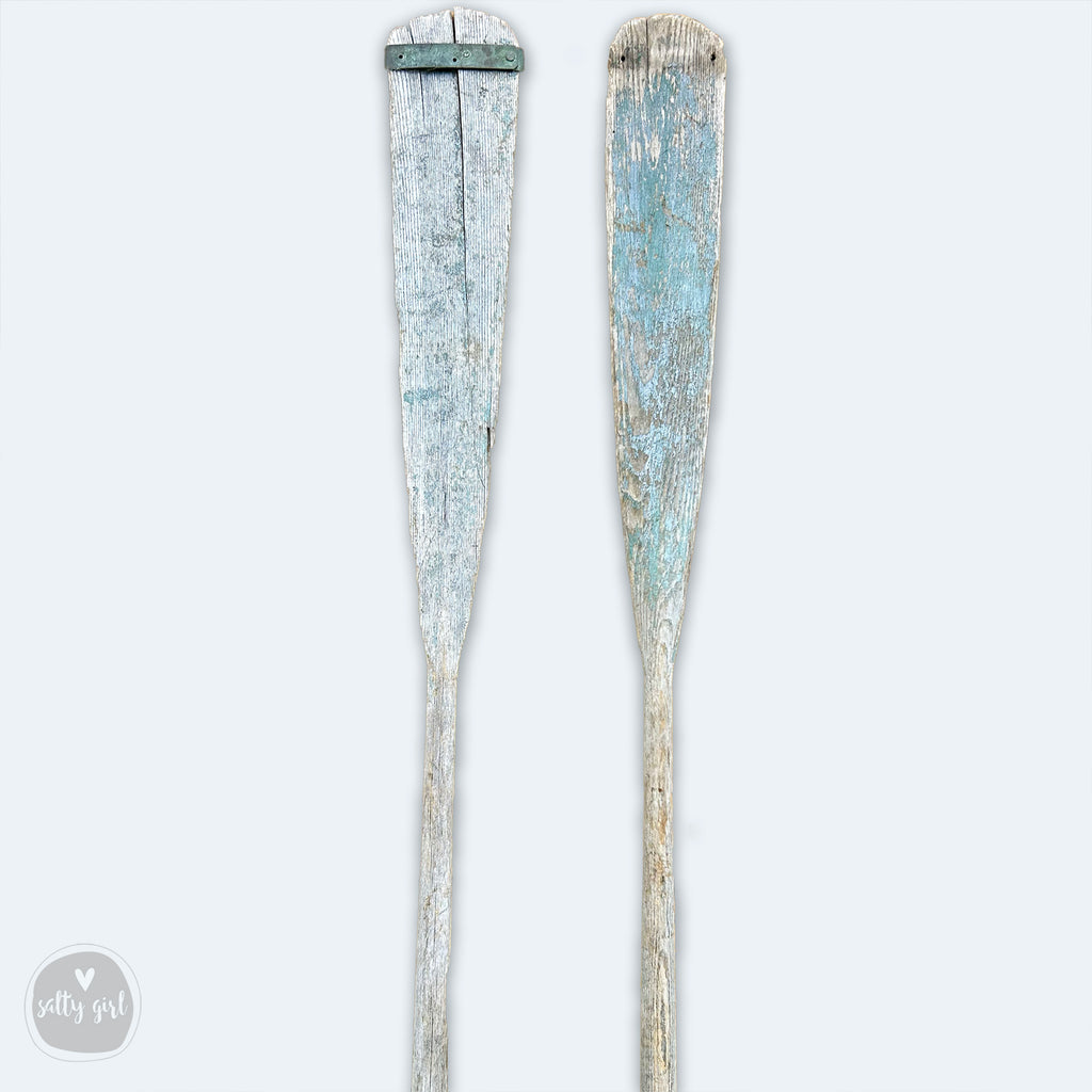 a pair of old toothbrushes sitting next to each other