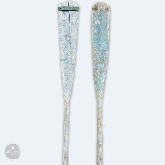 a pair of old toothbrushes sitting next to each other