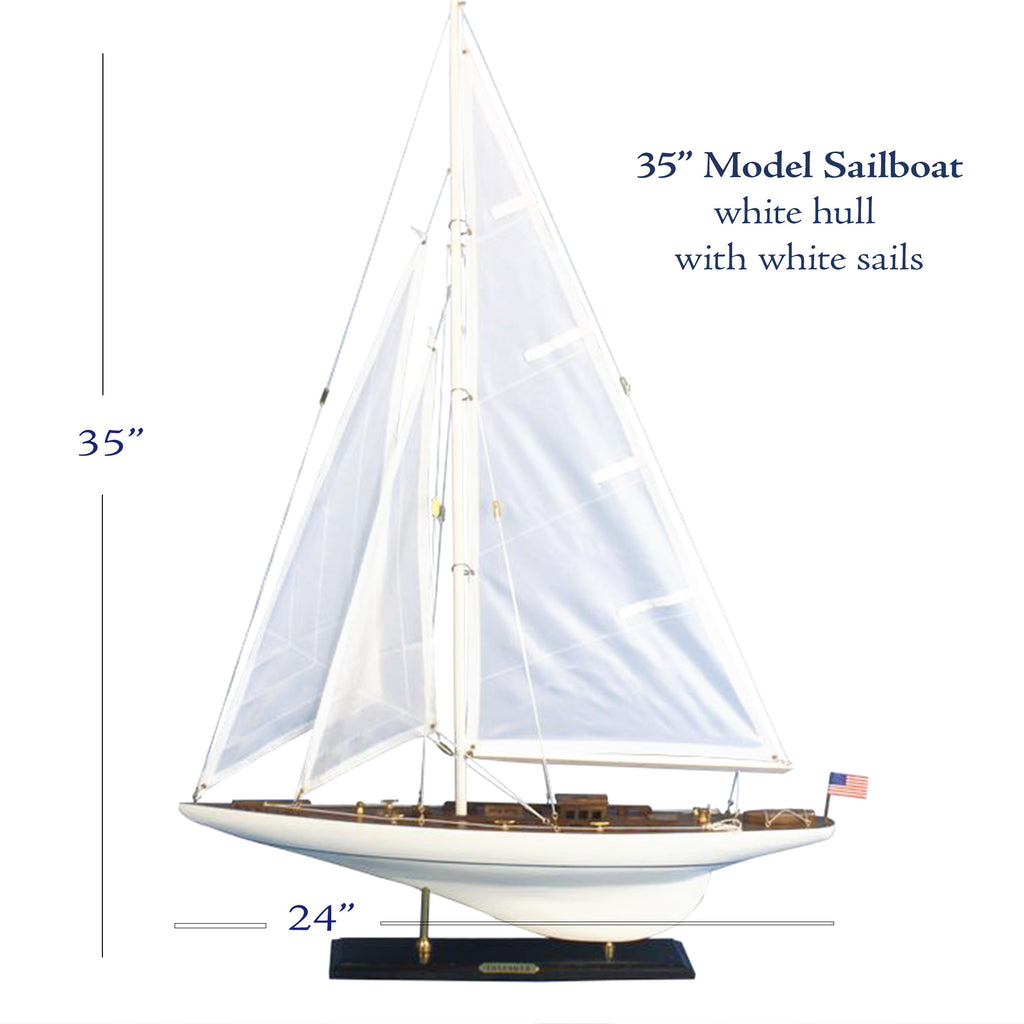 A 35" Model Sailboat with white hull and white sails, standing on a black base.