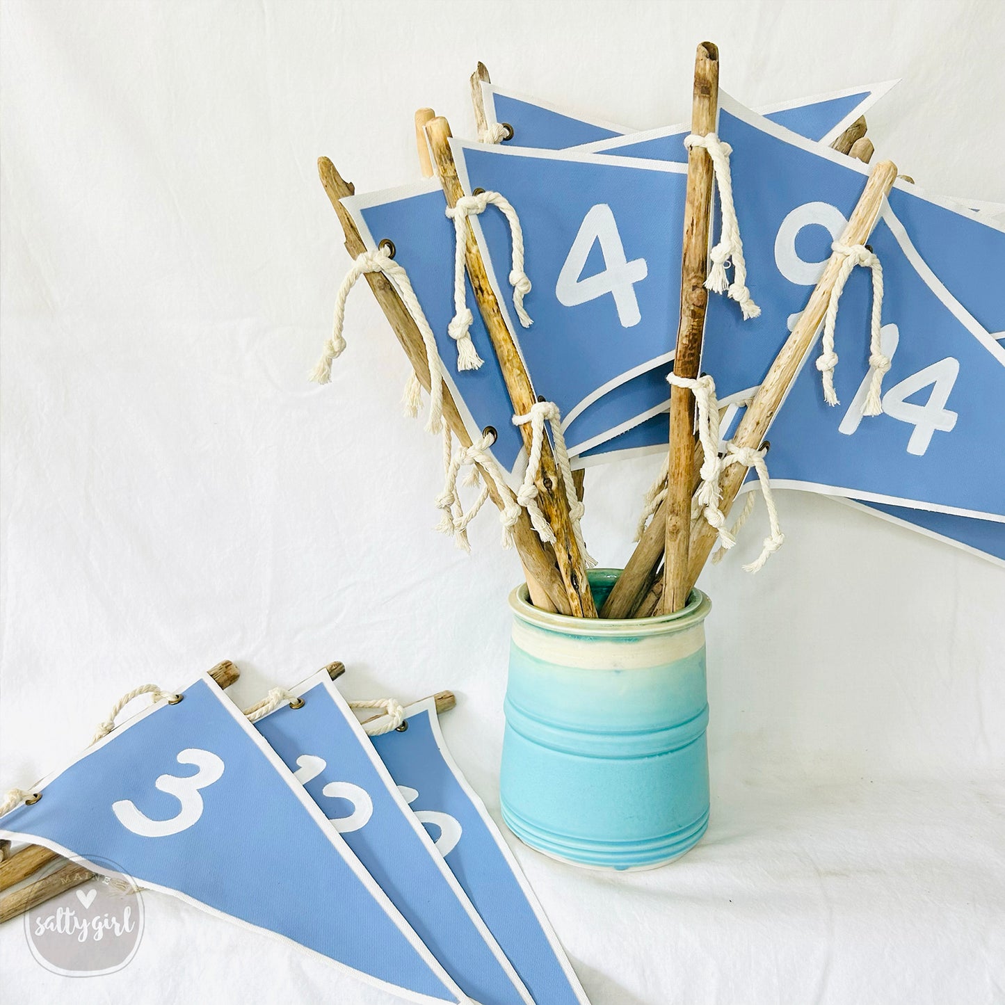 a vase filled with sticks and a number sign