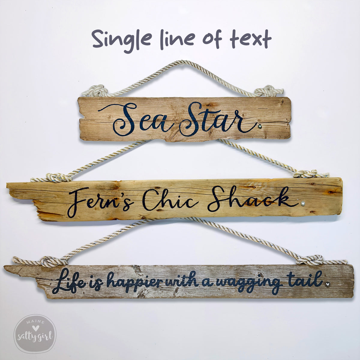 three wooden signs hanging on a wall, each with a different message written on it. The first sign says "Sea Star", the second sign says "Fern's Chic Shack", and the third sign says "Life is happier with a wagging tail".